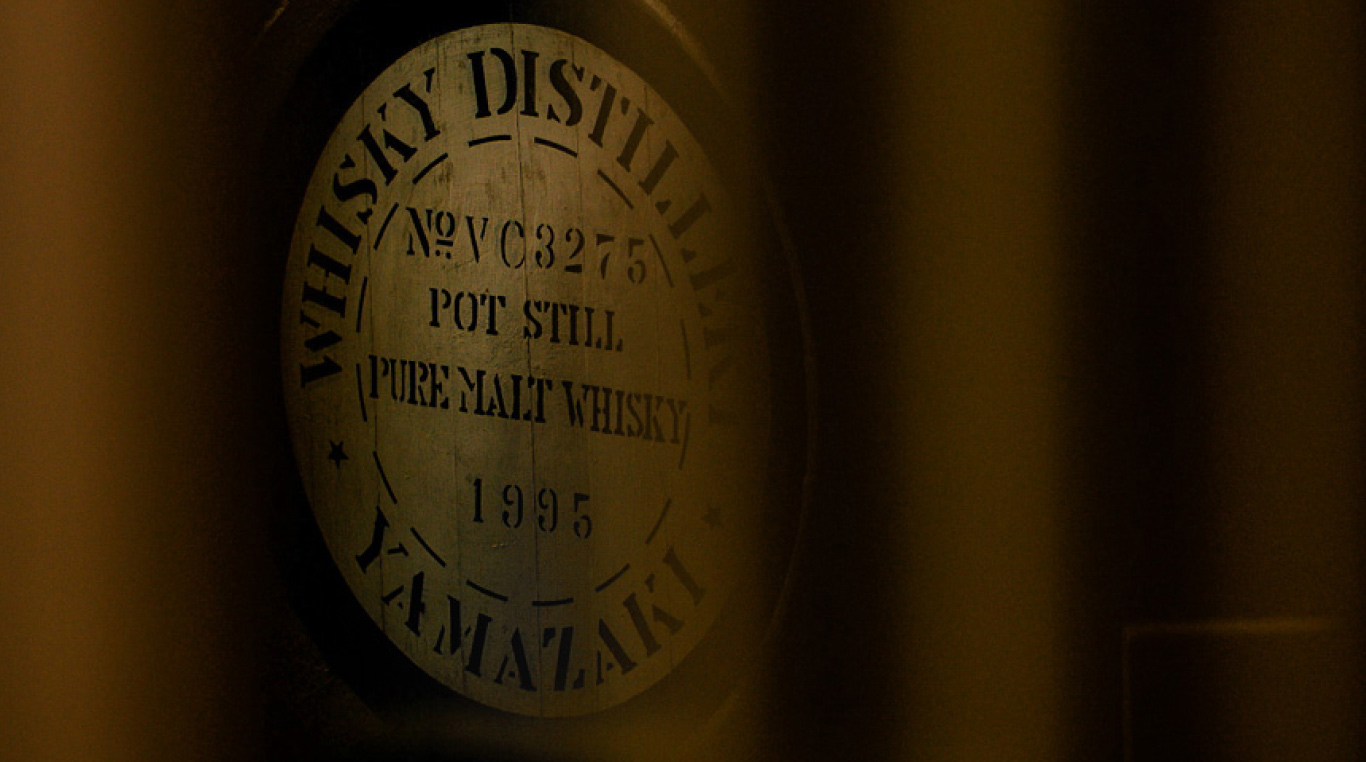 A close-up of a vintage Yamazaki whisky distillation label, featuring "Pot Still" and "Pure Malt Whisky 1995" details in bold text.