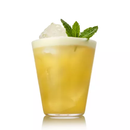 Suntory Toki Whisky Sour cocktail with egg white foam and mint garnish