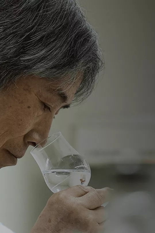 Man sniffing glass of Haku Vodka