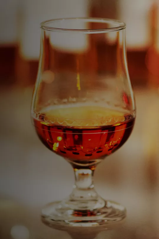 Tulip glass filled with amber Hibiki Suntory Whisky