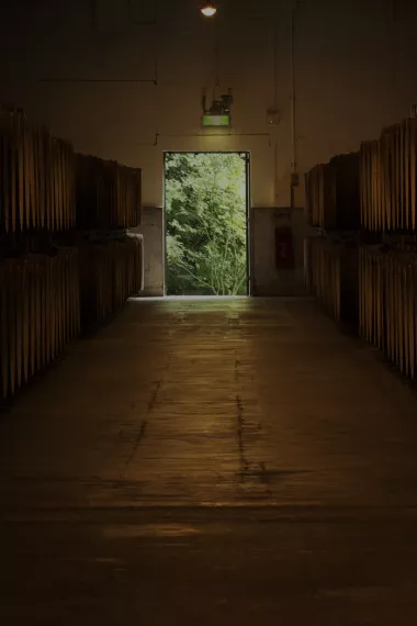 A long hallway within the Suntory Distillery lined with oak barrels
