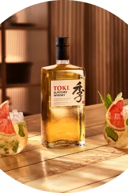 Bottle of Suntory Whisky Toki and two whisky mint julep cocktails