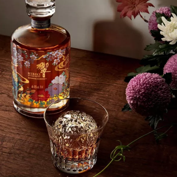 Iconic cylindrical glass bottle of Suntory Hibiki Whisky with hand-painted flowers