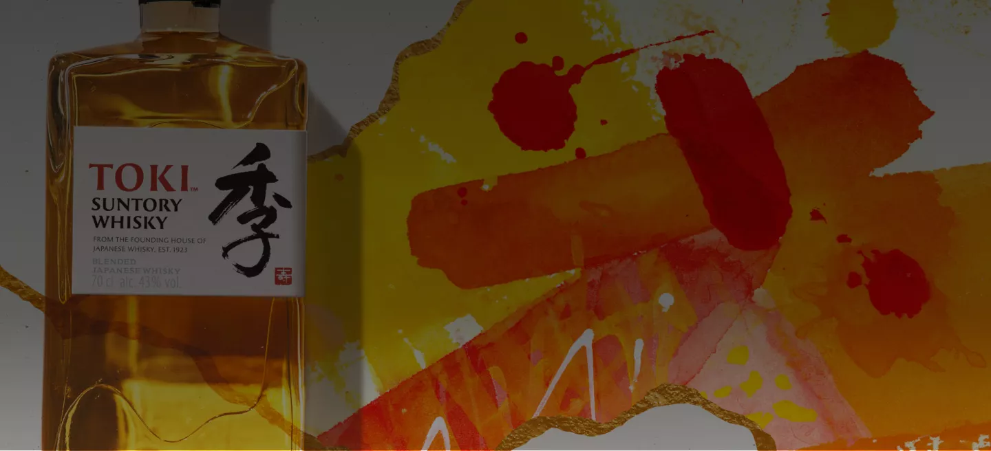 Toki Whisky bottle close up with vibrant orange and yellow art behind