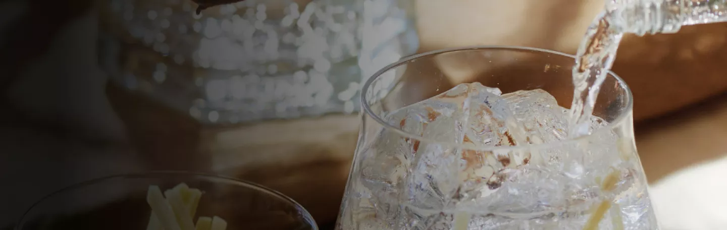 close up of Roku gin being poured into glass over ice