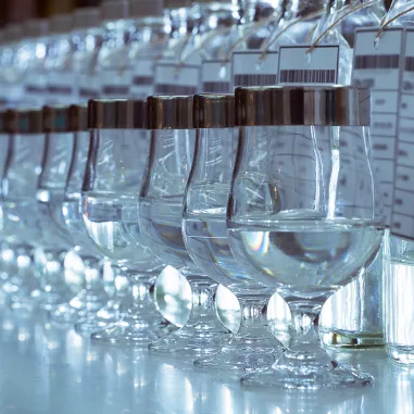 Filling whisky glasses with Gin at Osaka Distillery