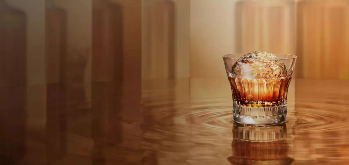 Old fashioned glass with Suntory whisky over large round ice cube