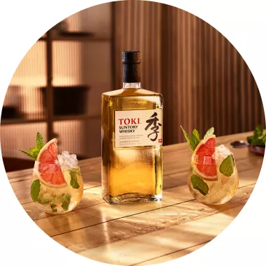 Bottle of Suntory Whisky Toki and two whisky mint julep cocktails