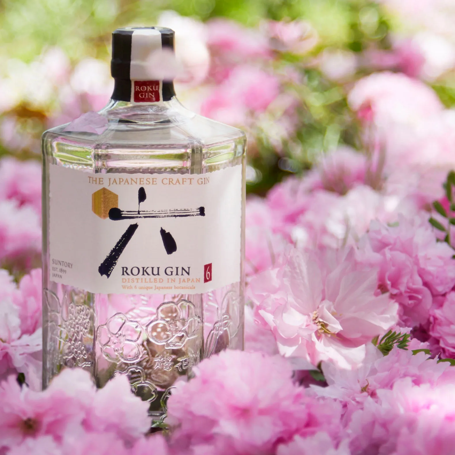 Roku gin bottle on blossom flowers