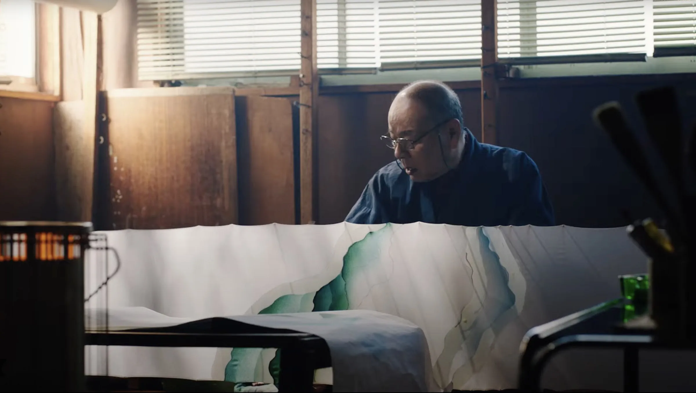 man looking at down on a huge painting