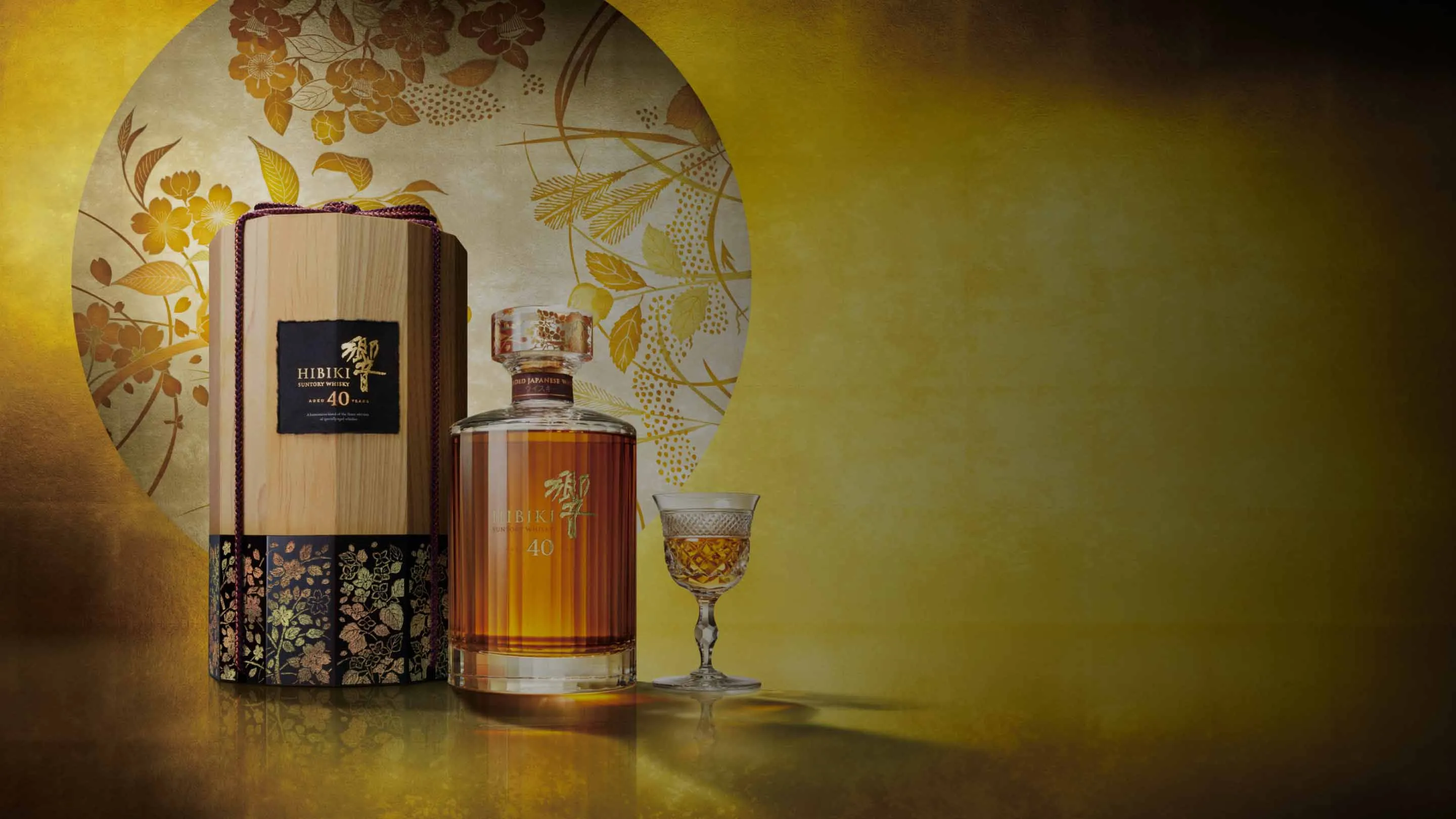 bottle of whisky beside a glass of red wine, elegantly displayed on a wooden surface, showcasing a refined beverage selection.