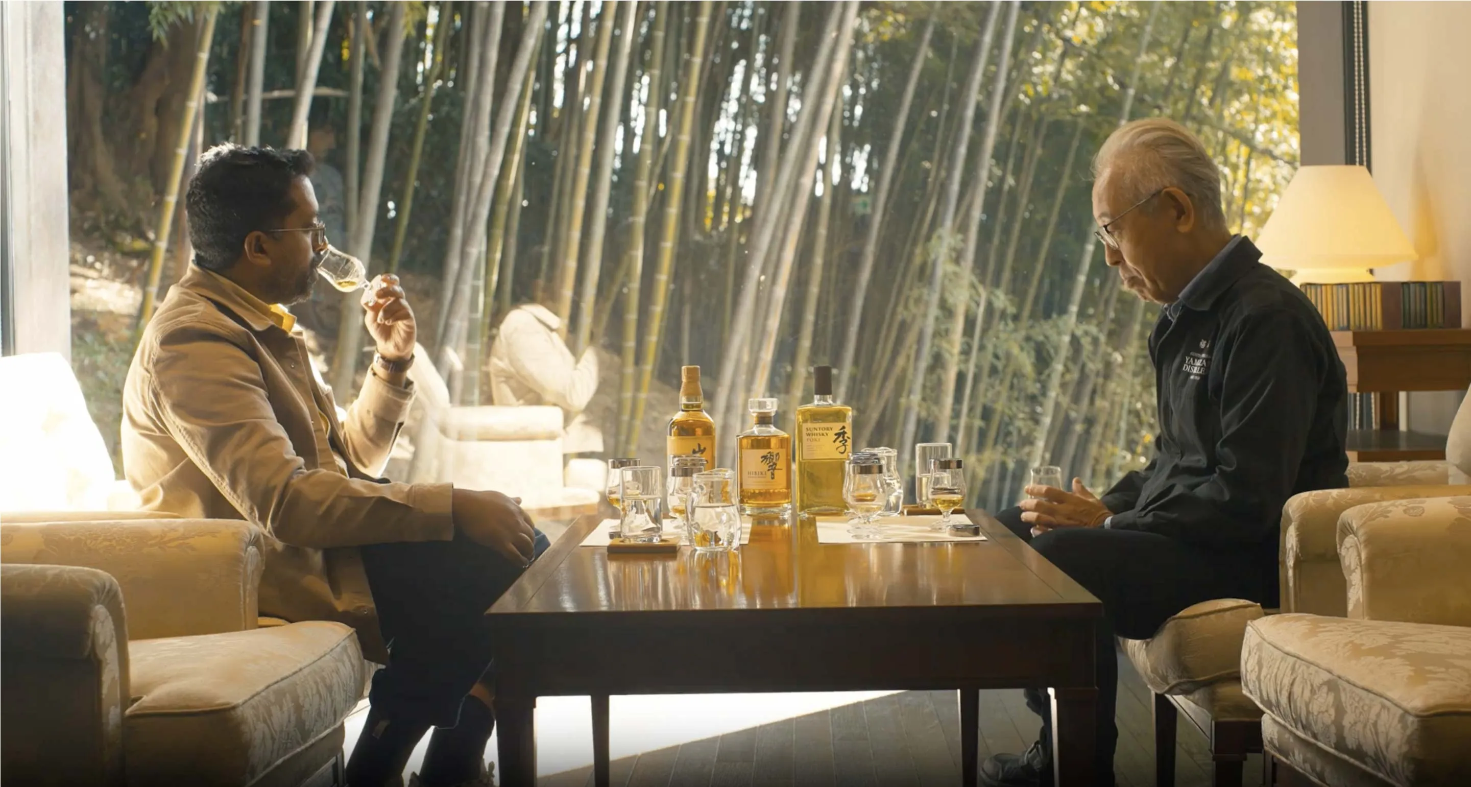 two persons sitting together enjoying whisky