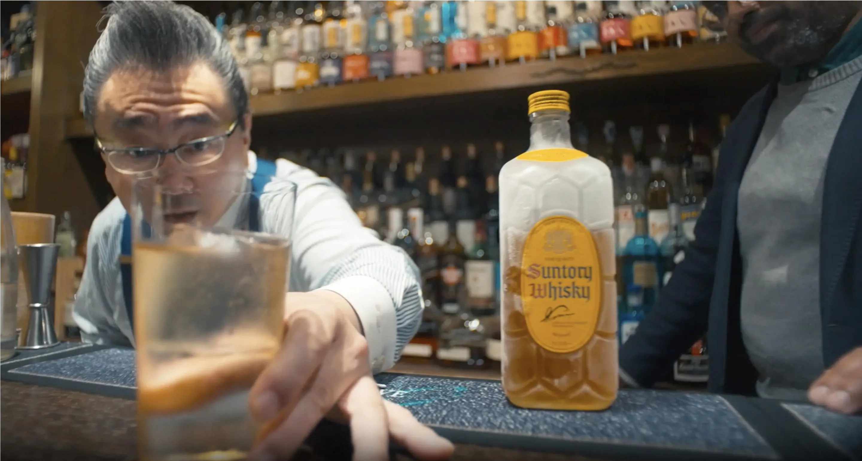 bartender holding a glass of whisky 