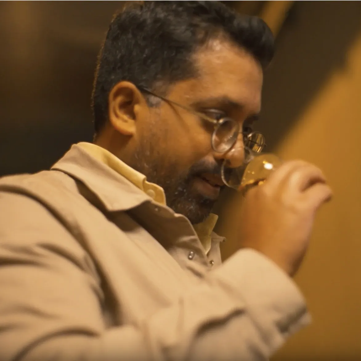 Mr. Lyan smelling whisky from whisky glass