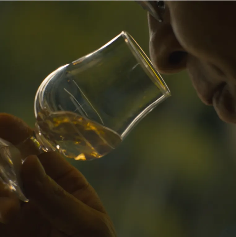 Shinji smelling aroma of whisky from whisky glass